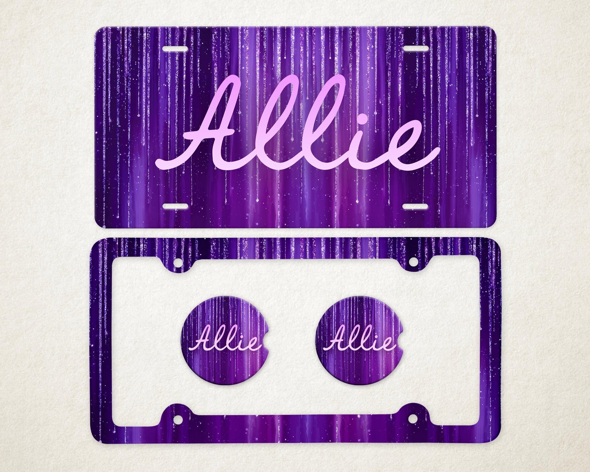 May include: A purple license plate and frame set with the name "Allie" in a cursive font. The background has a vertical streak design. Two matching car coasters are included, each with the name "Allie".