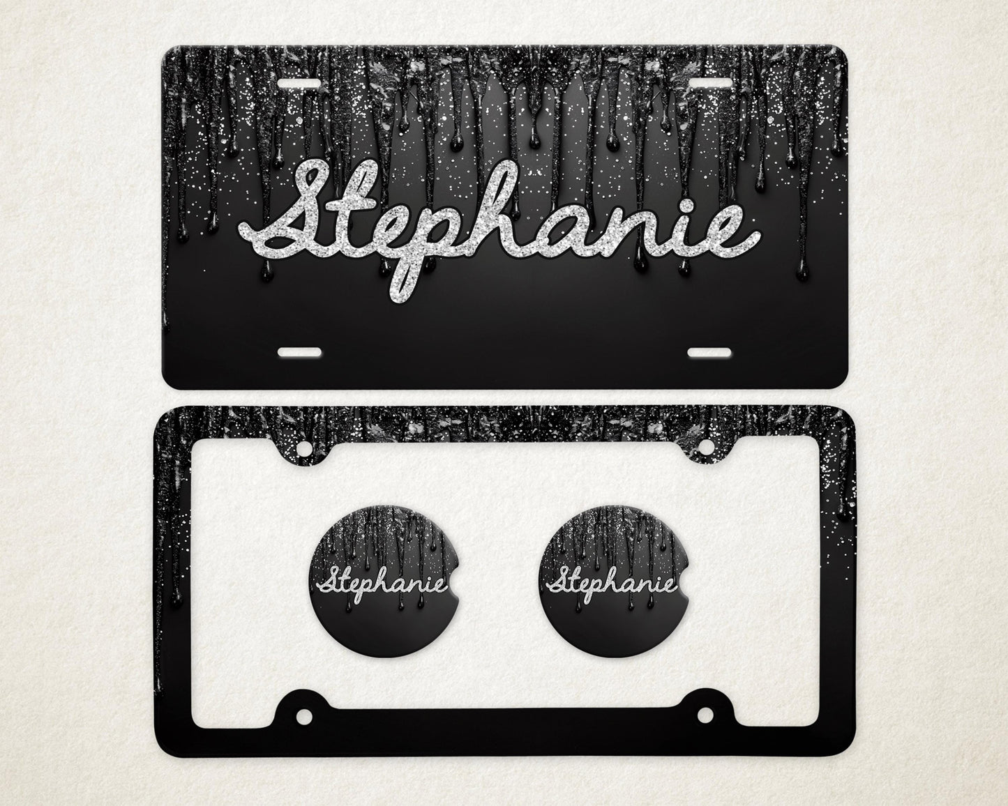 May include: Black license plate with a dripping paint design and the name "Stephanie" in silver glitter script. Includes a matching black license plate frame and two car coasters with the name "Stephanie".